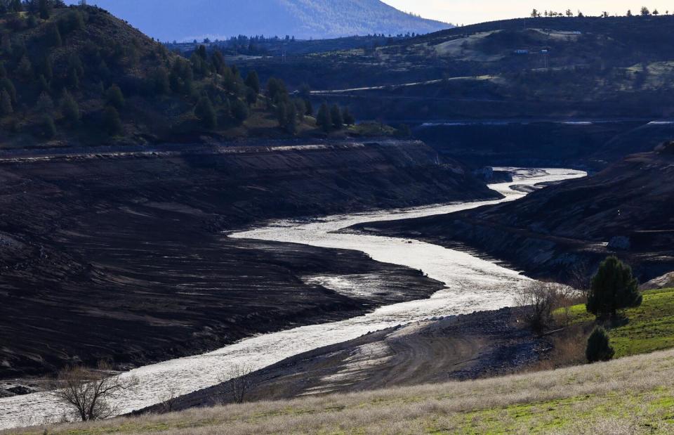 The Klamath River flows unimpeded after dams were removed, revealing lands that had been underwater.