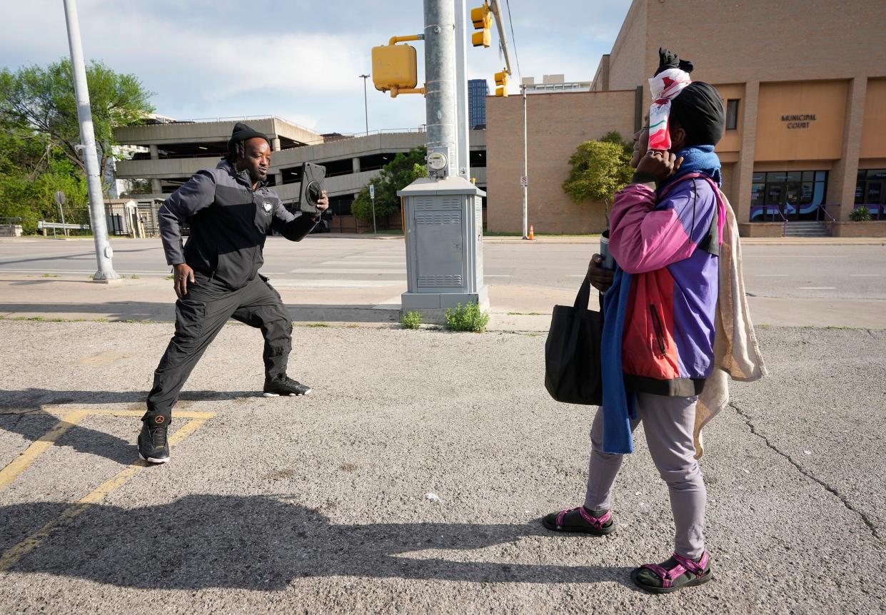 L.D. Davis photographs Natalie Campbell while gathering her information during his rounds. Campbell, who told the Statesman she was experiencing homelessness, said she had known Davis for a while and said he was "easy to talk to."