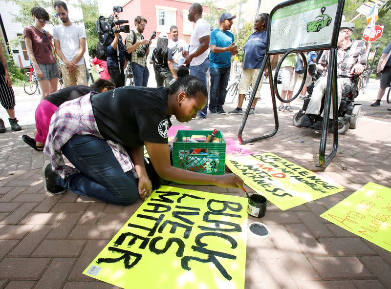 FILE PHOTO: Hadayo Ali prepares a Black Lives Matter sign before a protest march in Ottawa