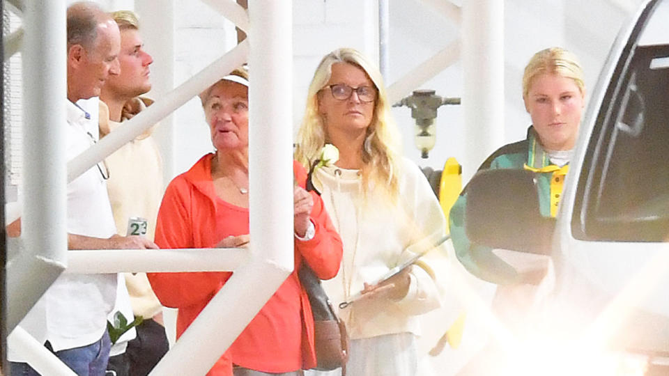 Pictured here, several members of Warne's immediate family were at at the hangar in Melbourne waiting for his body to return home from Thailand.