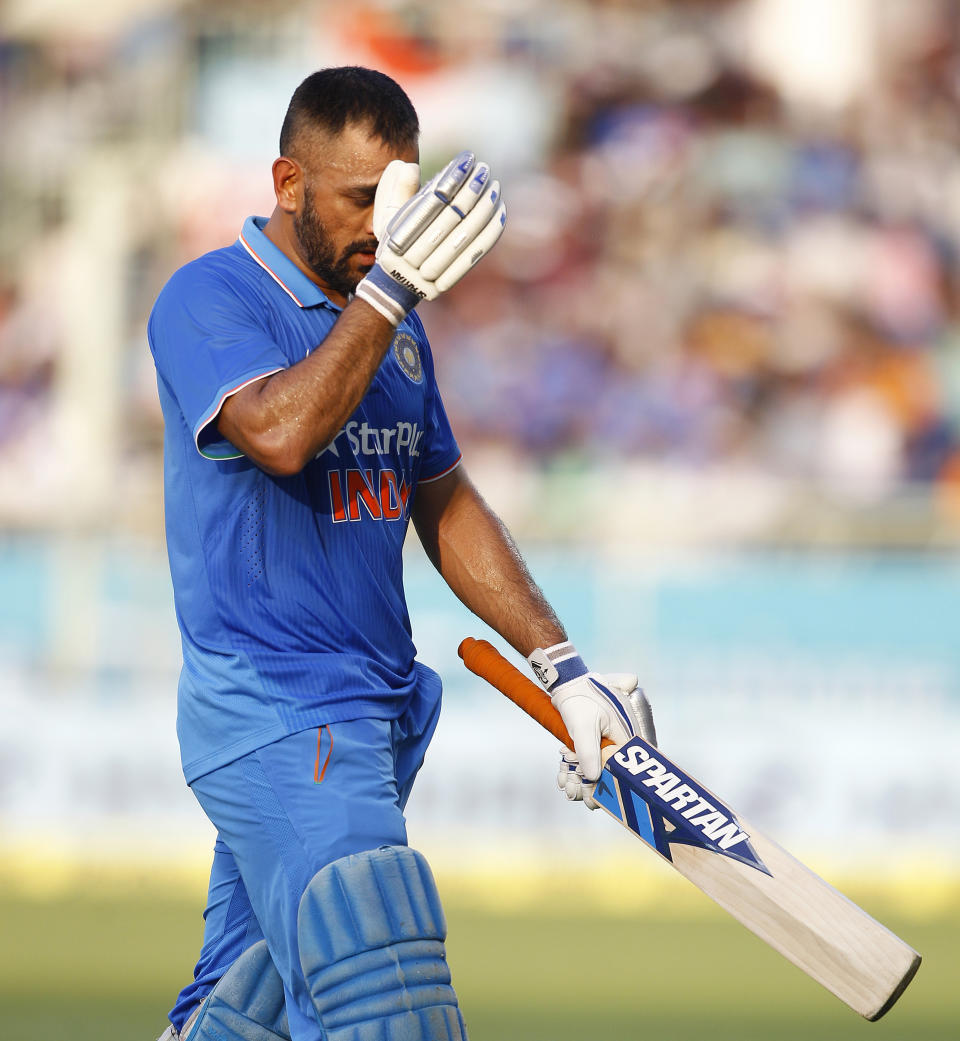 FILE - In this Saturday, Oct. 29, 2016, file photo, Indian cricket captain Mahendra Singh Dhoni leaves the ground after being dismissed during the fifth and last one day international cricket match against New Zealand in Visakhapatnam, India. India great Dhoni announced his retirement from international cricket on Saturday, Aug. 15, 2020. Under Dhoni’s stewardship, India won the T20 World Cup in 2007, the 50-over World Cup in 2011 and the Champions Trophy in 2013. (AP Photo/Aijaz Rahi, File)