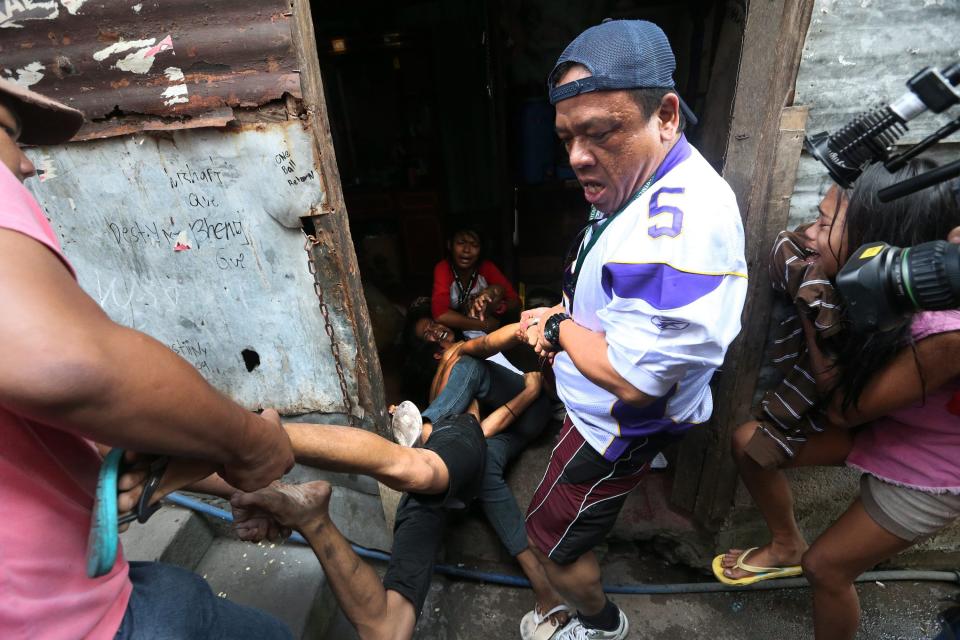 epa04044204 Filipino informal settlers Penny Mercado (3-R) hugs her husband Brix, 27, (2-L) while being arrested by plainclothes policemen inside their house during a demolition of shanties at Sitio San Roque in Quezon City, east of Manila, Philippines, 27 January 2014. Throwing rocks, pillboxes, and even human waste, illegal settlers barricaded the demolition team in Baranggay Bagong Pag-asa. Four residents were arrested and twelve were reported injured. Residents report receiving cash from 300 to 450 US dollar in exchange for their voluntary relocation. Earlier, hundreds of the urban poor marched to the city hall in protest of the demolition that will pave the way for the rise of a business district. EPA/DENNIS M. SABANGAN