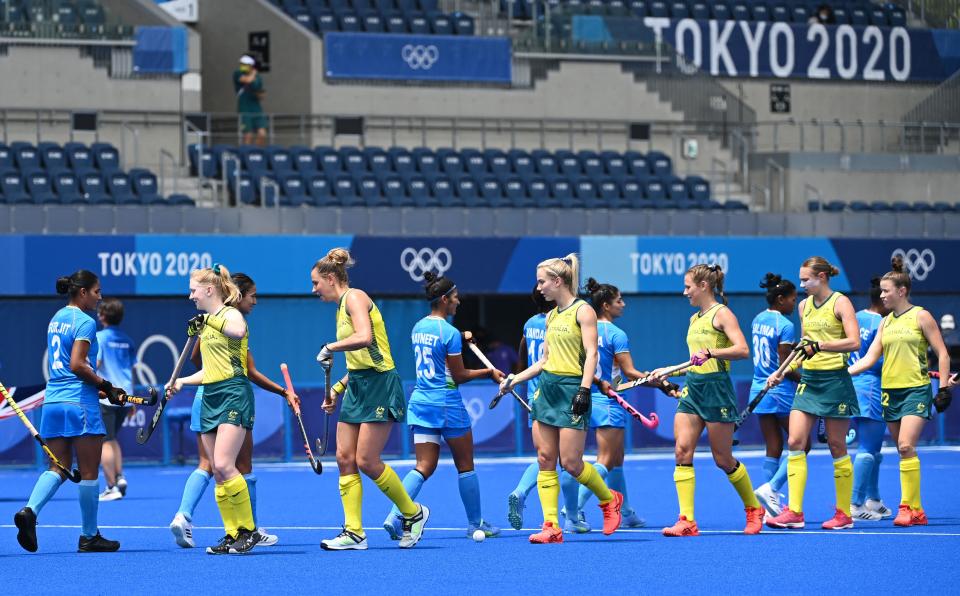 Players of India (light blue) and Australia greet each other before their women's quarter-final match of the Tokyo 2020 Olympic Games field hockey competition, at the Oi Hockey Stadium in Tokyo, on August 2, 2021. (Photo by CHARLY TRIBALLEAU / AFP) (Photo by CHARLY TRIBALLEAU/AFP via Getty Images)
