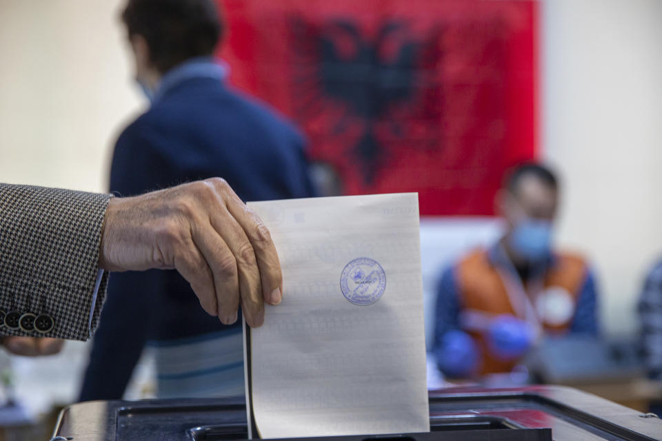 A man casts his ballot during parliamentary elections in capital Tirana, Albania, Sunday, April 25, 2021. Albanians are voting in parliamentary elections amid the virus pandemic and a bitter political rivalry between the two largest political parties. (AP Photo/Visar Kryeziu)