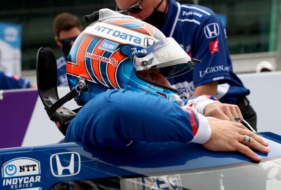 Chip Ganassi Racing driver Tony Kanaan (48) climbs into his car Saturday, May 22, 2021, during qualifying for the 105th running of the Indianapolis 500 at Indianapolis Motor Speedway. 