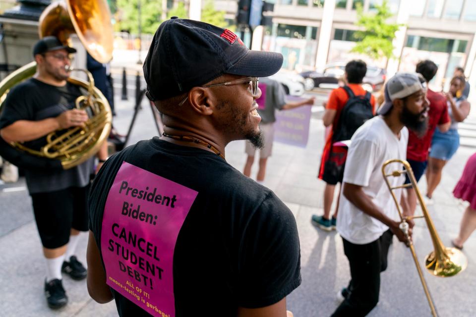 Too Much Talent Band performs during a rally to urge President Joe Biden to cancel student debt near the White House in Washington, D.C., Wednesday, July 27, 2022.