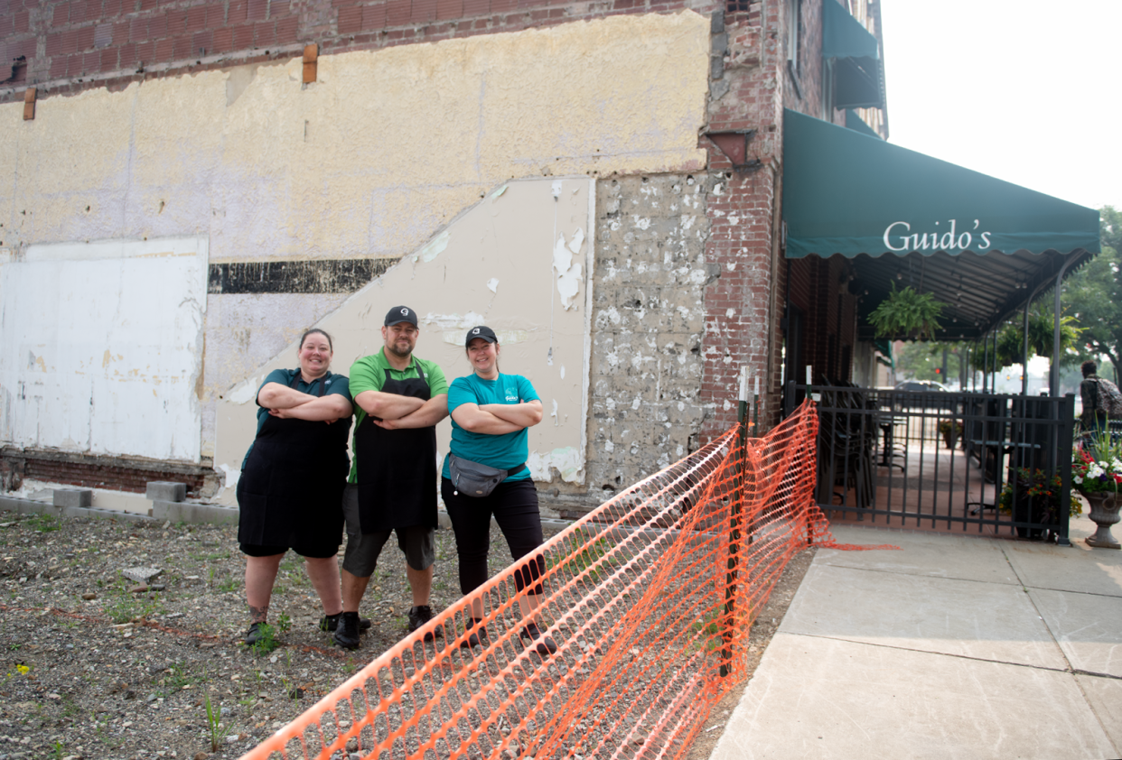 Guido's managers Melissa Long, Scott Hutchinson and Mindy Leonard stand on the proposed spot of a patio in downtown Ravenna.