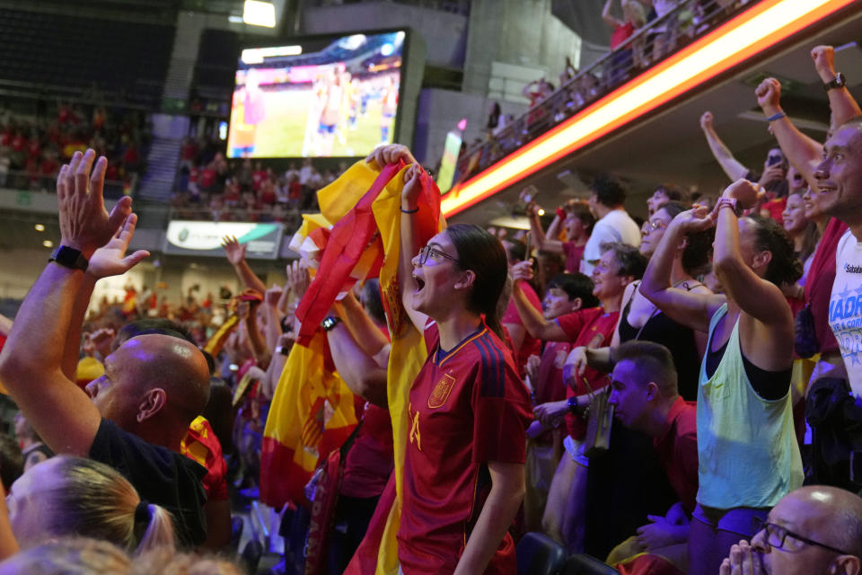 Spanish fans celebrate Spain's victory as they watch the Women's World Cup final soccer match between Spain and England on a large screen, in Madrid, Spain, Sunday, Aug. 20, 2023. (AP Photo/Paul White)