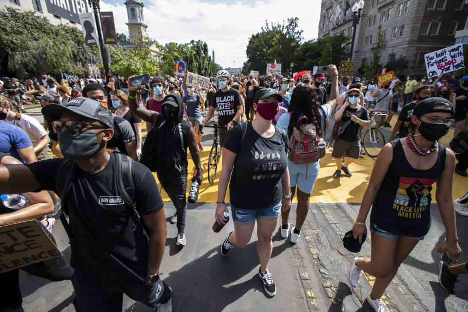 Marchers chant as they gather along a section of 16th Street, Northwest, renamed Black Lives Matter Plaza, near the White House in Washington, during the March on Washington, Friday, Aug. 28, 2020, commemorating the 57th anniversary of the Rev. Martin Luther King Jr.'s "I Have A Dream" speech. (AP Photo/Manuel Balce Ceneta)