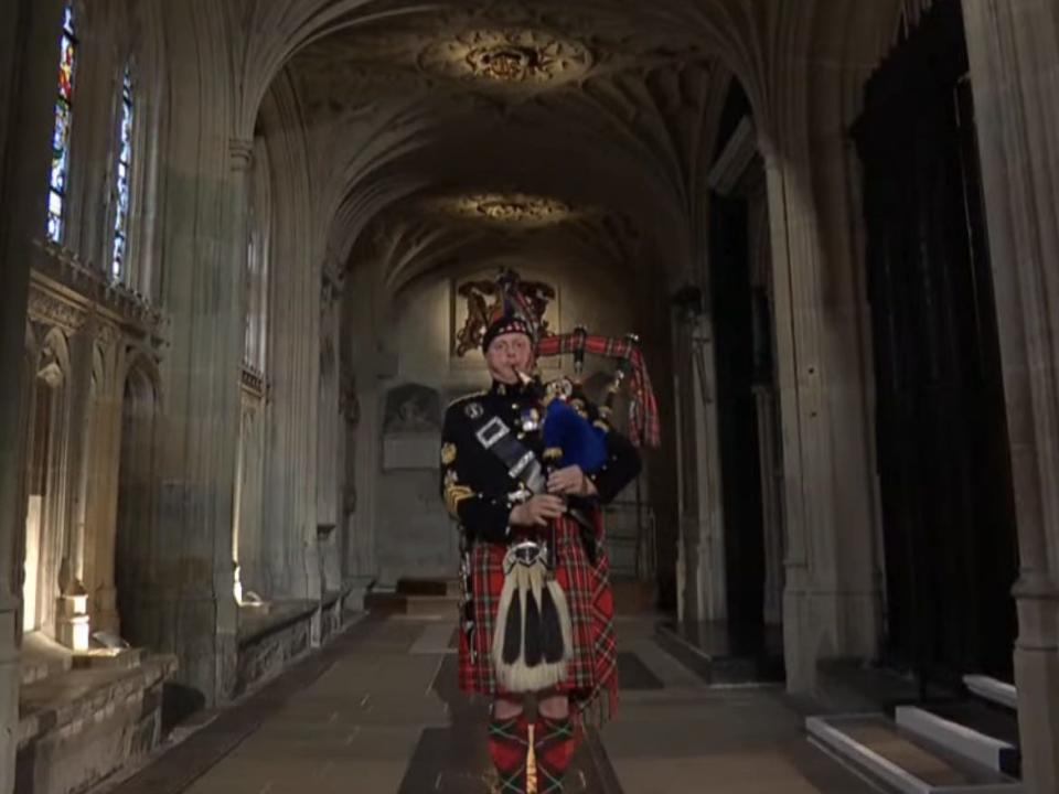 queen's piper playing a lament at st George chapel for funeral committal
