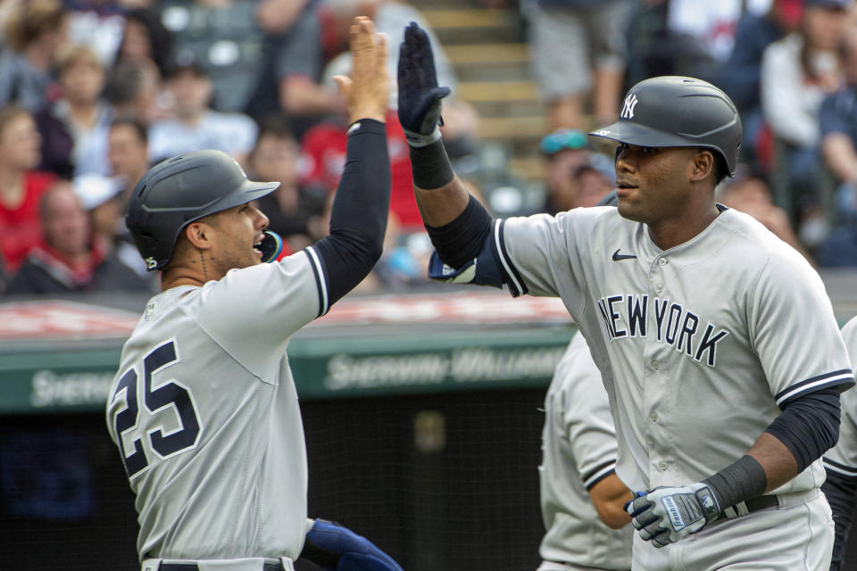 New York Yankees' Gleyber Torres (25) congratulates Franchy Cordero after his three-run home run off Cleveland Guardians starting pitcher Hunter Gaddis during the third inning of a baseball game in Cleveland, Tuesday April 11, 2023. (AP Photo/Phil Long)