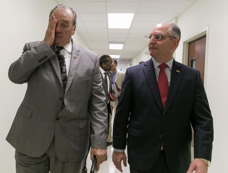 St. Landry Parish Sheriff Bobby Guidroz rubs his face as Louisiana Gov. John Bel Edwards looks on following a press conference on the arrest of a suspect Holden Matthews for the arson of three churches in Opelousas, La., Thursday, April 11, 2019. (AP Photo/Lee Celano)