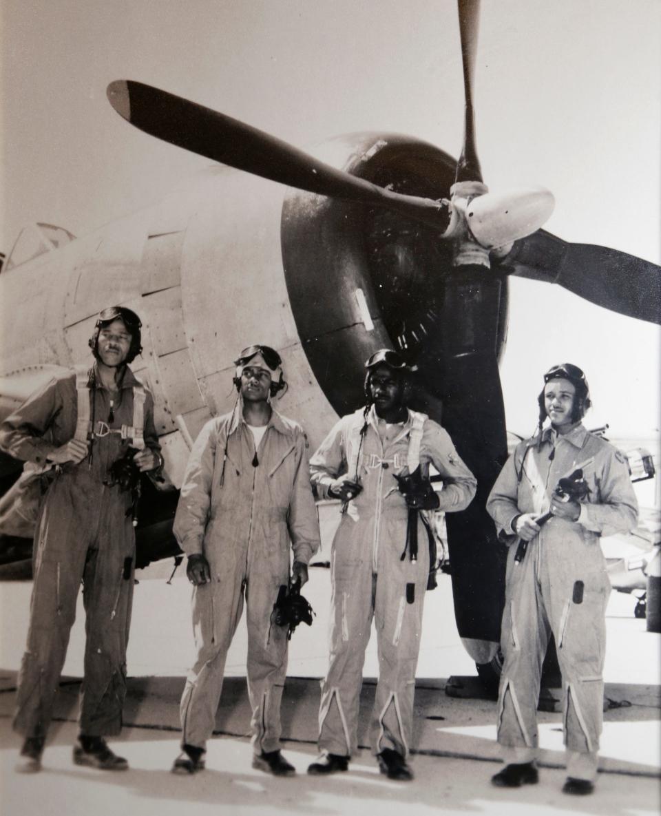 Tuskegee Airman Harry Stewart (second from left) in front of a P-51 Mustang during flight training with fellow airmen in Alabama.