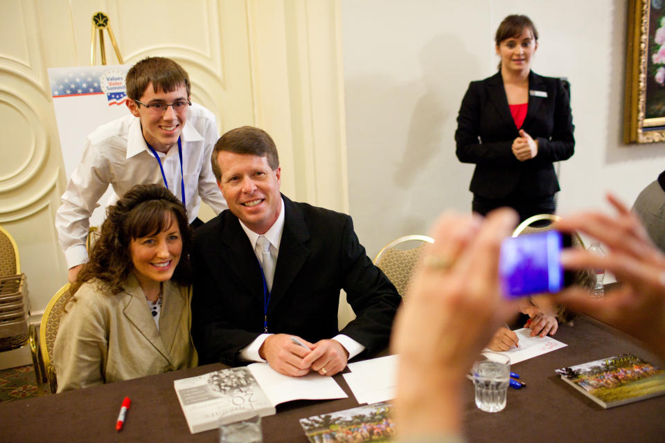 WASHINGTON - SEPTEMBER 17: Michelle Duggar and Jim Bob Duggar, stars of The Learning Channel TV show '19 Kids and Counting,' pose for a picture with a fan while signing copies of their book at the Values Voter Summit on September 17, 2010 in Washington, DC. The annual summit drew nearly two thousand people to advocate for conservative causes. (Photo by Brendan Hoffman/Getty Images)