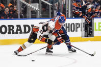 Anaheim Ducks' Jakob Silfverberg (33) and Edmonton Oilers' Mattias Janmark (26) compete for the puck during the second period of an NHL hockey game Saturday, April 1, 2023, in Edmonton, Alberta. (Jason Franson/The Canadian Press via AP)