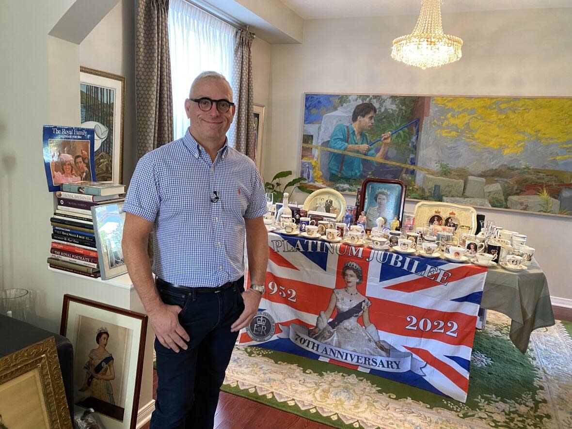 Derek Saikali stands in front of some of the pieces in his Royal collection. (Sannah Choi/CBC - image credit)