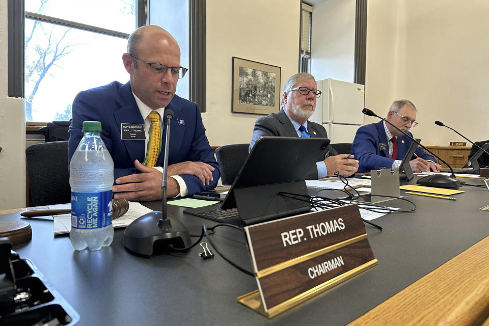 North Dakota Republican state Rep. Paul Thomas, at left, offers a remembrance, Tuesday, Oct. 3, 2023, at the state Capitol in Bismarck, N.D., for the late Republican state Sen. Doug Larsen, of Mandan, N.D., who died in a plane crash Sunday near Moab, Utah, with his wife, Amy, and their two young children. Next to Thomas is Republican state Sen. Cole Conley, who remembered Larsen for his love of hosting events and for meals he cooked for Senate caucus meetings. (AP Photo/Jack Dura)