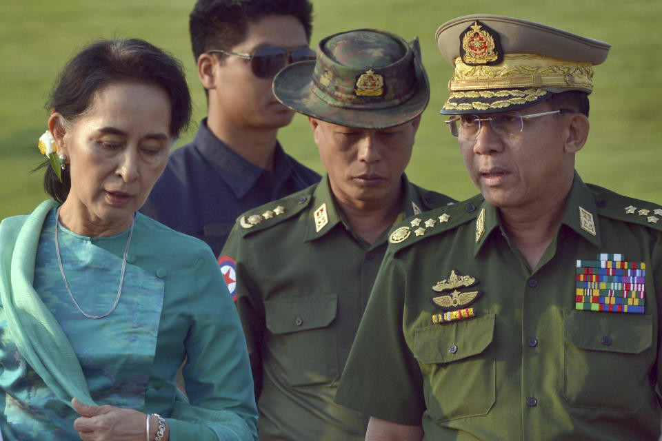 FILE - In this May 6, 2016, file photo, Aung San Suu Kyi, left, Myanmar's foreign minister, walks with senior General Min Aung Hlaing, right, Myanmar military's commander-in-chief, in Naypyitaw, Myanmar. Myanmar military television said Monday, Feb. 1, 2021 that the military was taking control of the country for one year, while reports said many of the country’s senior politicians including Suu Kyi had been detained. (AP Photo/Aung Shine Oo, File)