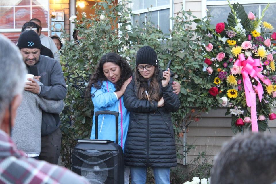 Fellow KMRI radio personality Monica Acuña, left, comforts Rocio Sifuentes during a vigil in honor of Gaby Ramos on Tuesday, 19 October. (Enrique Limón)