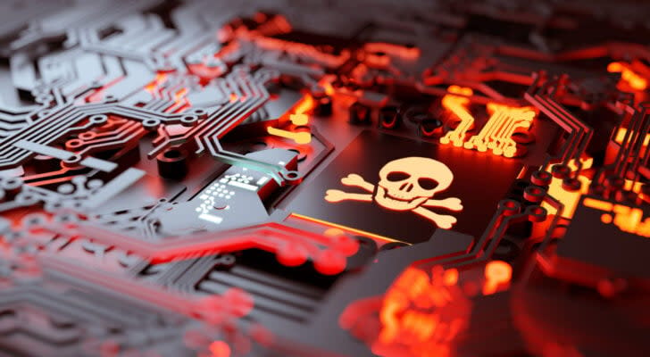 Graphic of skull on computer hardware with red glow beneath hardware. Tech stocks to sell