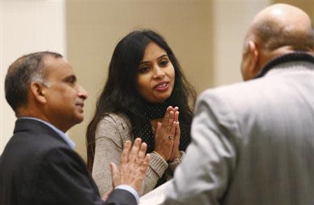 Devyani Khobragade (C) greets an unidentified guest as her father Uttam Khobragade (L) watches, at the Maharashtra Sadan after their meeting with Foreign Minister Salman Khurshid, in New Delhi January 11, 2014. REUTERS/Anindito Mukherjee/Files