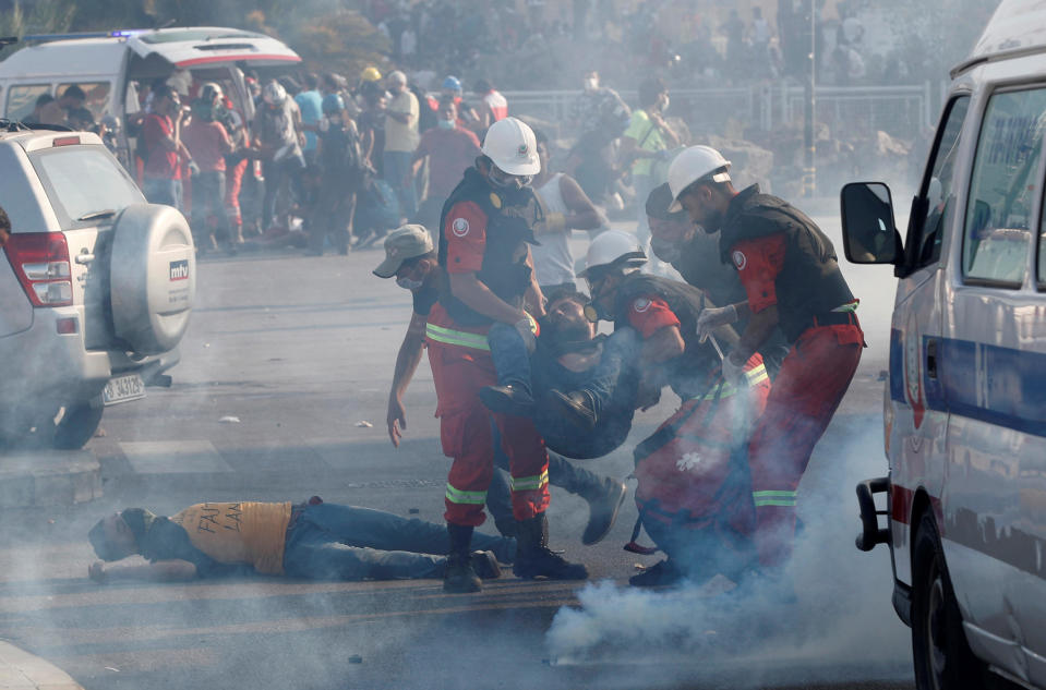 Rescuers assist demonstrators during a protest, following Tuesday's blast, in Beirut, Lebanon, on Saturday, August 8, 2020. / Credit: THAIER AL-SUDANI / REUTERS