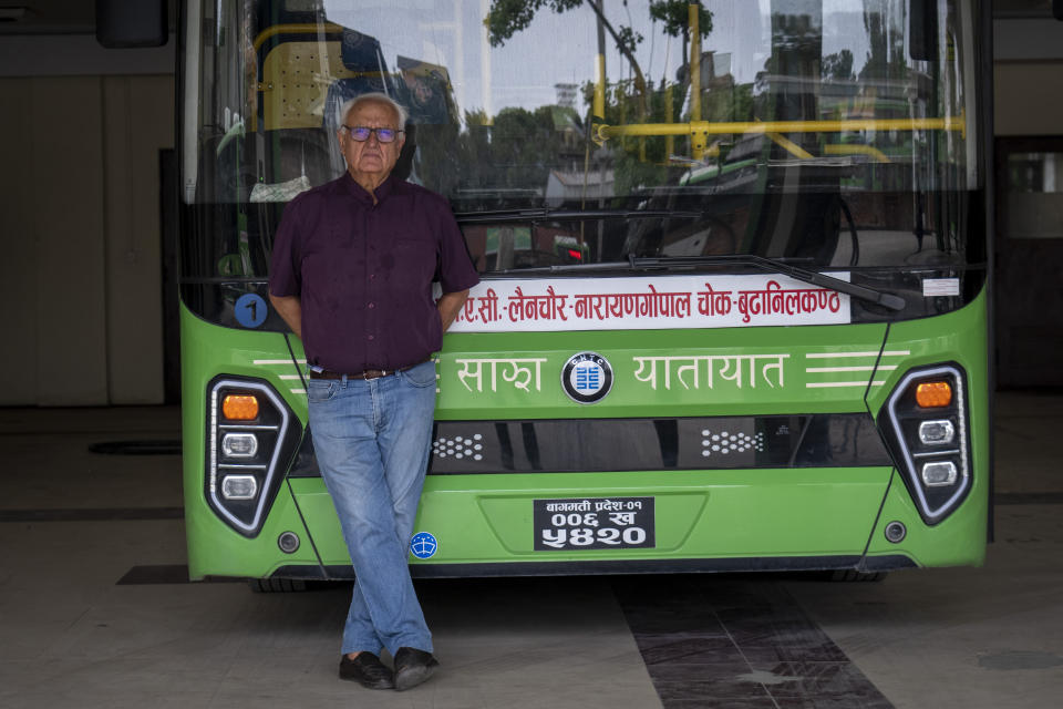 Kanak Mani Dixit, a leading environment and civil rights activist, poses in front of a public electric bus in Kathmandu, Nepal, Wednesday, May 22, 2024. “Our electricity in the grid is from hydropower so it is clean energy. And so Nepal is ideally placed to use electricity to run our vehicles in the best way it should be, which is that the energy source itself is clean. It is not coal, gas or nuclear or petroleum,” said Dixit, (AP Photo/Niranjan Shrestha)