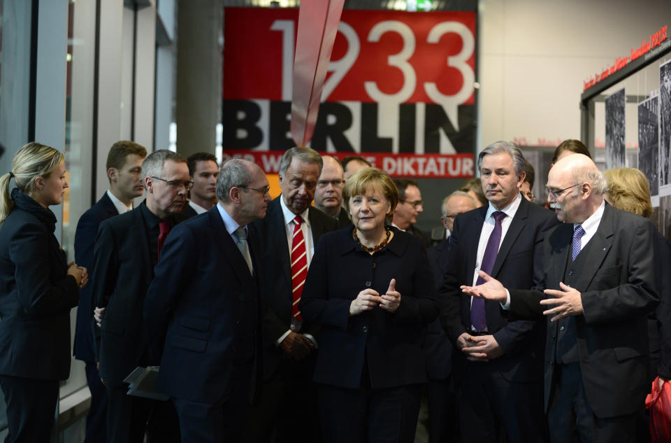 German Chancellor Angela Merkel (C) along with Berlin's mayor Klaus Wowereit (2nd R), Professor Andreas Nachama, managing director of 'Topographie des Terrors' (R), Bernd Naumann, Minister of State (4thL) and Professor Peter Steinbach, German historian and board member of the foundation, inaugurate the exhibition  'Berlin 1933 On the Path to Dictatorship', tracing Adolf Hitler's rise to power in Germany in 1933 to mark 80 years since he became chancellor on January 30, 2013 at the open-air documentation center Topographie des Terrors in Berlin. (JOHN MACDOUGALL/AFP/Getty Images)