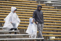 Fans are wrapped in rain gear before Colorado's spring NCAA college football game, Saturday, April 27, 2024, in Boulder, Colo. (AP Photo/David Zalubowski)