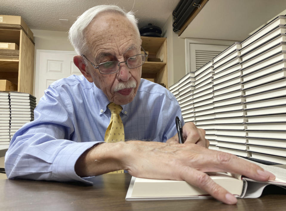 Alabama historian Wayne Flynt signs a copy of his new book, "Afternoons with Harper Lee," about the late author of "To Kill a Mockingbird," at a book-signing in Homewood, Ala., on Thursday, Sept. 22, 2022. Flynt and his late wife were friends with Lee, who died in 2016. (AP Photo/Jay Reeves)