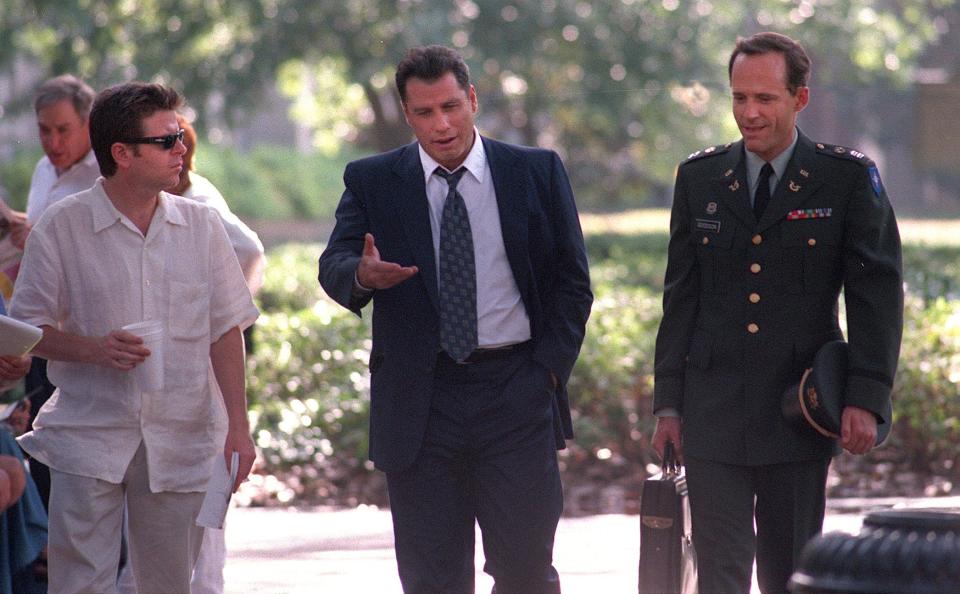 Simon West, left, director of "The General's Daughter" rehearses a scene with John Travolta and  John Benjamin Hickey where the two men walk through Madison Square talking. Bob Morris photo.
