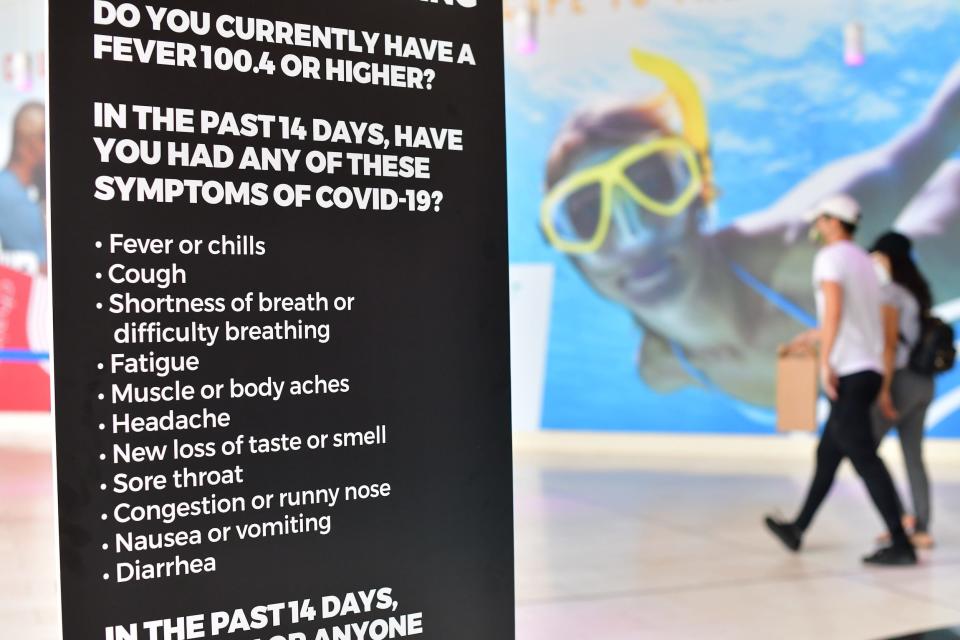 sign asks entering patrons if they feel symptoms associated with COVID-19 at Ocean Casino after it reopened on July 3, 2020 in Atlantic City, New Jersey