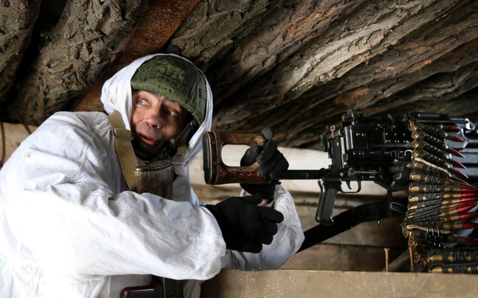 A serviceman checks his machine-gun in a shelter on the territory controlled by pro-Russian militants at the frontline with Ukrainian government forces near Spartak village in Yasynuvata district of Donetsk region, eastern Ukraine, Thursday, Jan. 27, 2022. - AP Photo