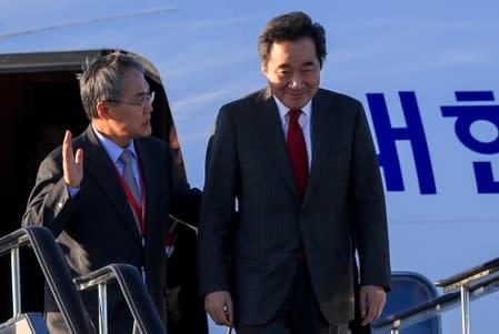 South Korean PM Lee Nak-yon and Ambassador to Russia Woo Yoon-keun disembark from a plane to attend the upcoming Eastern Economic Forum in Vladivostok, on the tarmac at Vladivostok International Airport