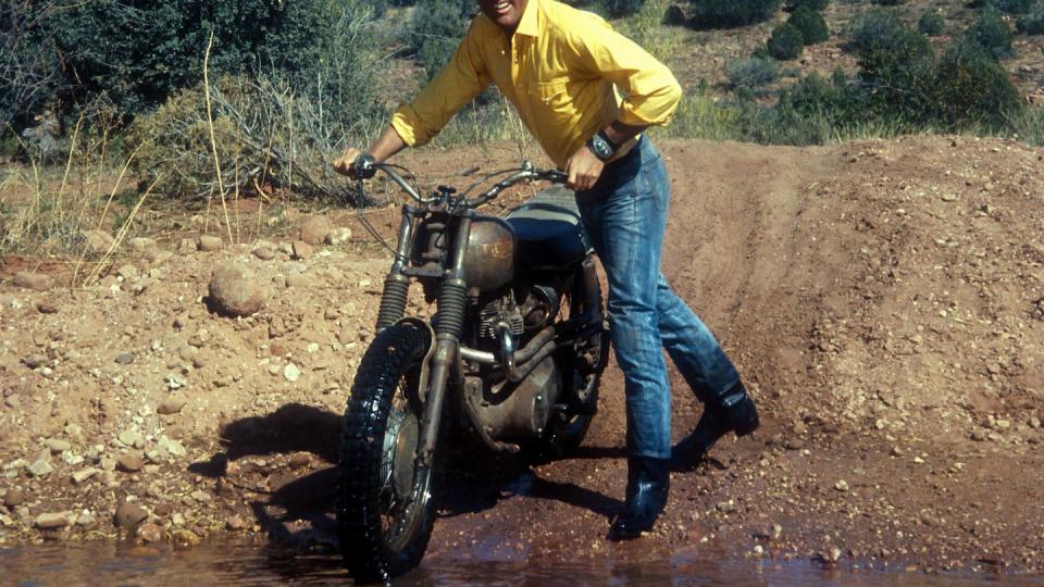 elvis presley walking triumph motorcycle in desert