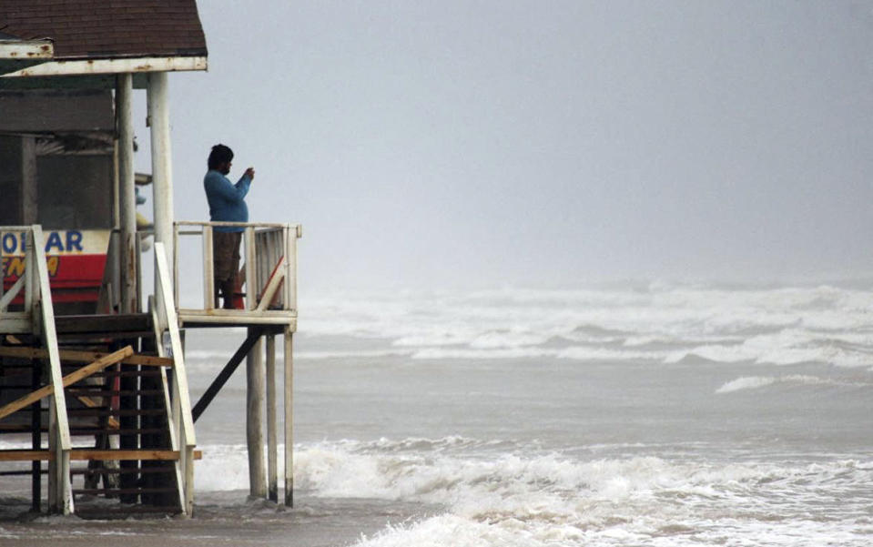 A man takes pictures before the arrival of Tropical Storm Alberto at Bagdad Beach in Matamoros, Tamaulipas State, Mexico, on June 19, 2024. (Photo by ABRAHAM PINEDA / AFP) (Photo by ABRAHAM PINEDA/AFP via Getty Images)