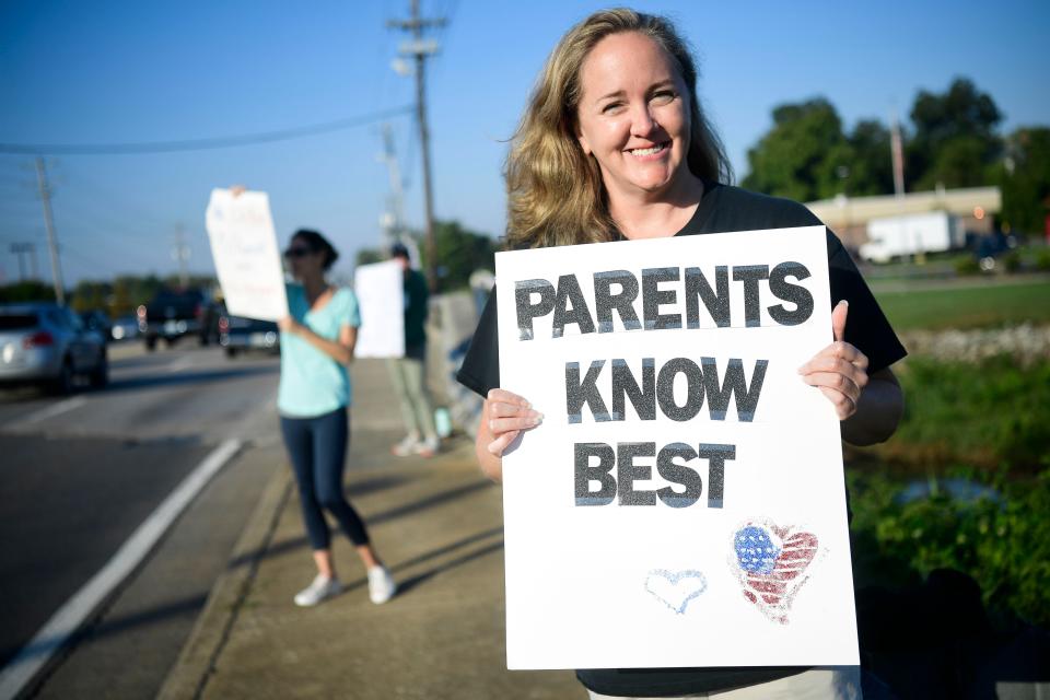 A protestor voices their opposition to the school mask mandate on the corner of Kingston Pike and West End Ave. in Farragut, Tenn. on Tuesday, Sept. 28, 2021.