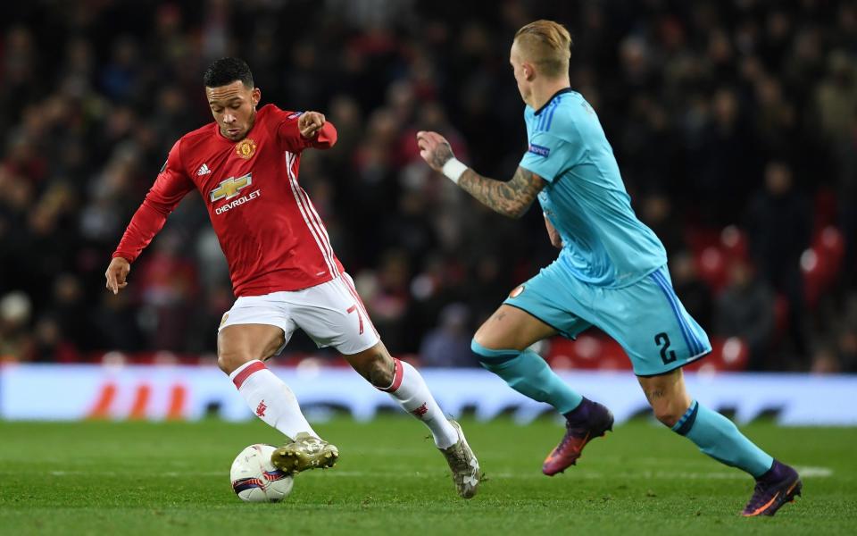 Memphis Depay of Manchester United is watched by Rick Karsdorp of Feyenoord during the UEFA Europa League Group A match between Manchester United FC and Feyenoord  - Getty Images