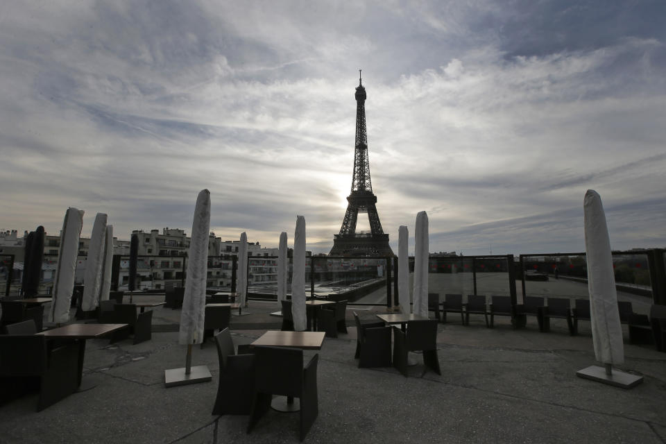 The suns sets on an empty restaurant terrace near the Eiffel Tower in Paris, Tuesday, Nov. 20, 2012. In a setback for President Francois Hollande's Socialist government, Moody's Investors Service stripped Europe's No. 2 economy of it of its prized AAA credit rating late Monday on concerns that its rigid labor market and exposure to Europe's financial crisis were threatening its prospects for economic growth. (AP Photo/Francois Mori)