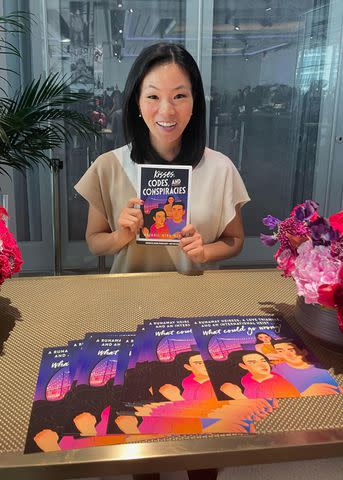 <p>Courtesy of Abigail Hing Wen</p> Wen holding a copy of her new book