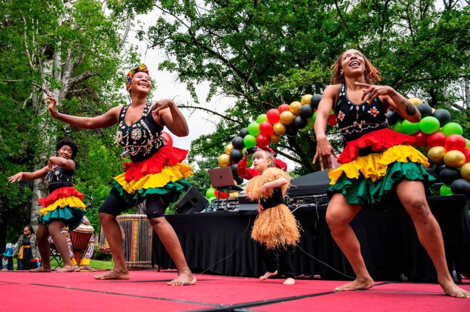 From left to right, Olivia Frieson, Sheimawu Abubakari, Sylvie Williams and Chelleea ChassionBashay with the Tacoma Performing Arts Center, dance on stage during the third annual Juneteenth celebration at Wright Park in Tacoma, Wash. on Saturday, June 18, 2022. Cheyenne Boone/cboone@thenewstribune.com