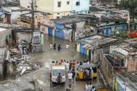 Residents make their way on a flooded street following heavy rains in Hyderabad on October 14, 2020. (Photo by NOAH SEELAM / AFP) (Photo by NOAH SEELAM/AFP via Getty Images)