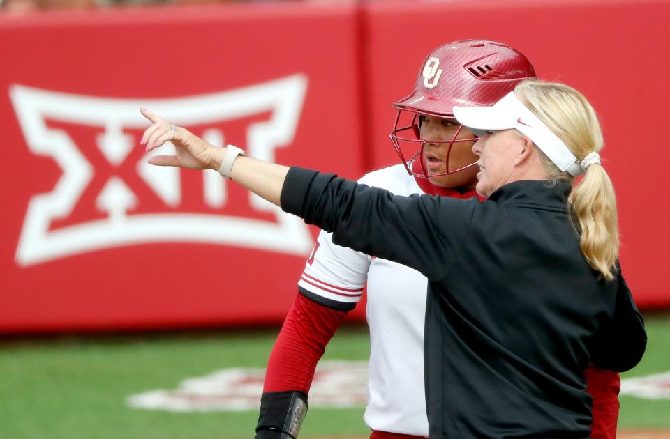 Oklahoma head coach talks with Oklahoma's Ella Parker (5) during the Bedlam college softball game between the University of Oklahoma Sooners and the Oklahoma State University Cowgirls at Love's Field in Norman, Okla., Sunday, May, 5, 2024.