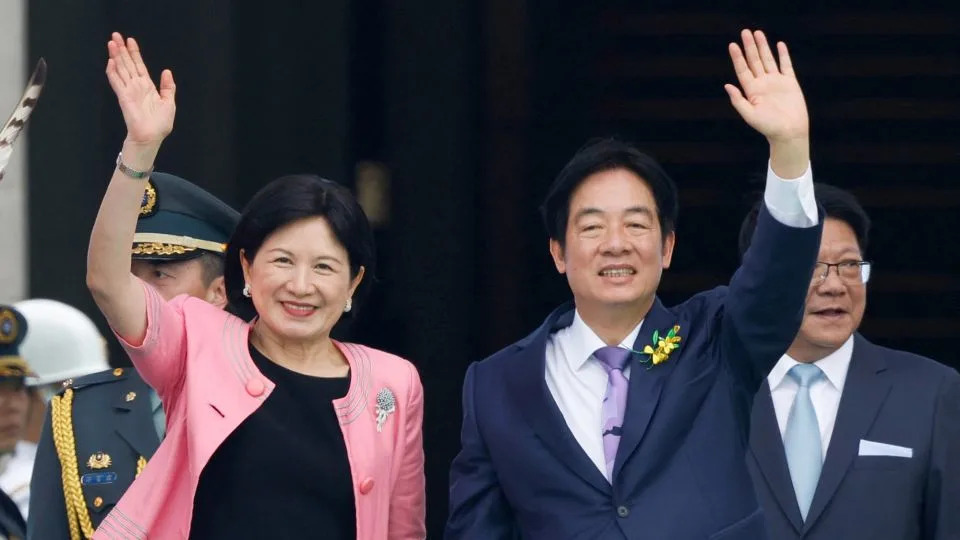 Taiwan's new President Lai Ching-te and his wife Wu Mei-ju wave during the inauguration ceremony in Taipei on May 20, 2024. - Carlos Garcia Rawlins/Reuters