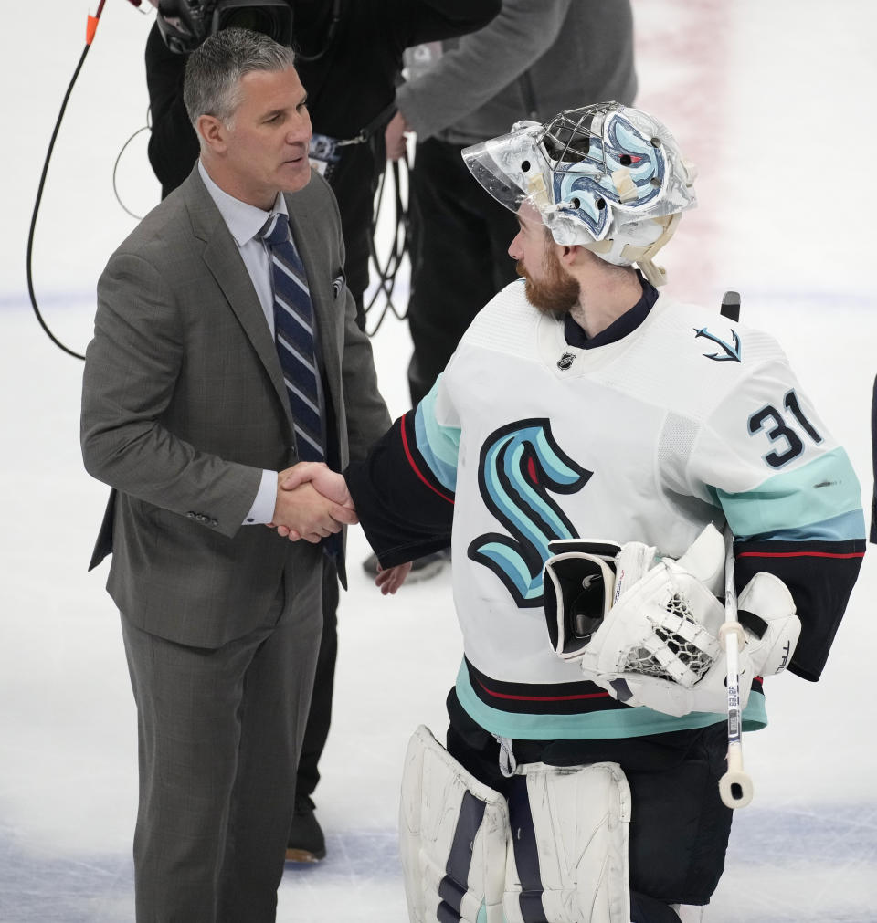 Colorado Avalanche head coach Jared Bednar, left, congratulates Seattle Kraken goaltender Philipp Grubauer after the third period of Game 7 of an NHL first-round playoff series Sunday, April 30, 2023, in Denver. The Kraken won 2-1 to advance to the next round. (AP Photo/David Zalubowski)