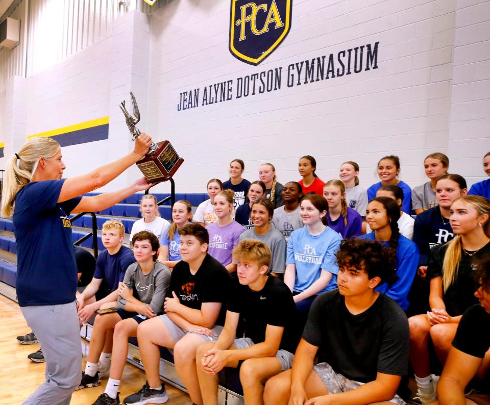 PCA’s Athletic Director Tara James presents the DNJ All Sports Award for the 2023-24 school year, to PCA student athletes, as they cheer after their win on Tuesday, June 11, 2024, at the school.