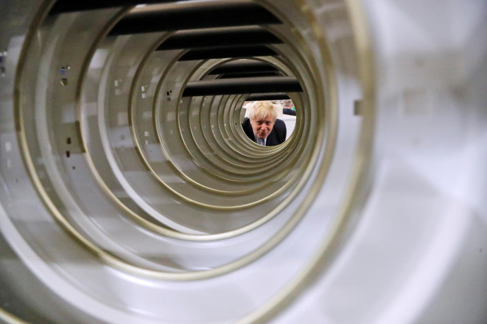 Britain's Prime Minister Boris Johnson looks at doors of washing machines at Ebac electrical appliances manufacturer during a General Election campaign trail stop in Newton Aycliffe, Britain November 20, 2019. Frank Augstein/Pool via REUTERS     TPX IMAGES OF THE DAY