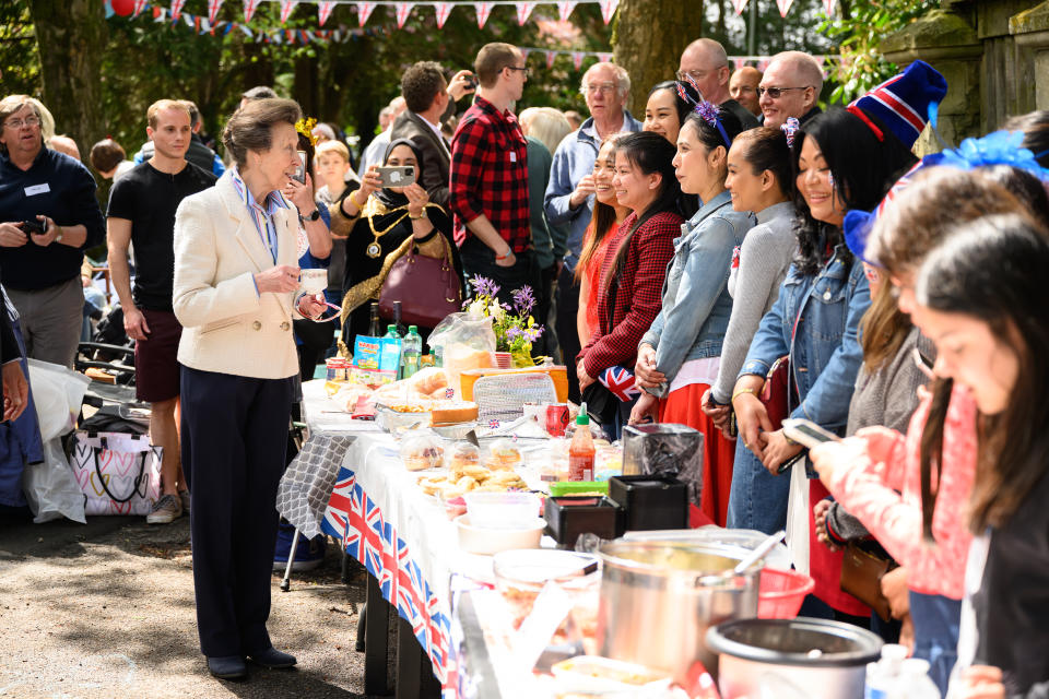 SWINDON, ENGLAND - MAY 07: Princess Anne (L) speaks with residents of a street as they hold a Coronation street party on May 07, 2023 in Swindon, England. The weekend of Coronation celebrations will continue this evening with a the Coronation Concert in the grounds of Windsor Castle later, featuring artists including Lionel Richie, Katy Perry and Take That. (Photo by Leon Neal/Getty Images)