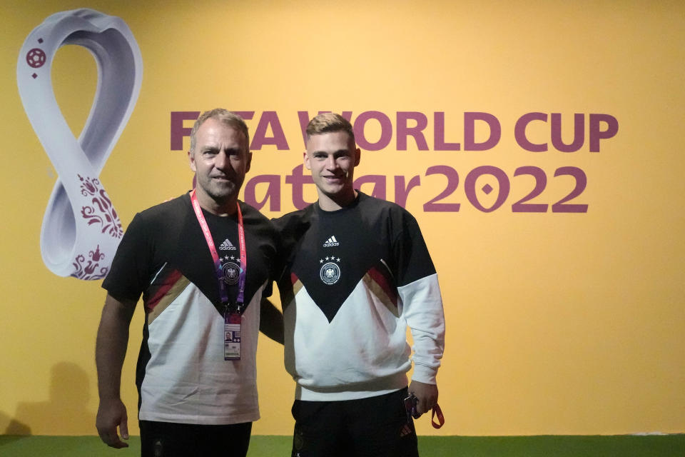 Germany's head coach Hansi Flick, left, and player Joshua Kimmich arrive for a news conference on the eve of the group E World Cup soccer match between Germany and Japan, in Doha, Qatar, Tuesday, Nov. 22, 2022. Germany will play the first match against Japan on Wednesday, Nov. 23. (AP Photo/Matthias Schrader)