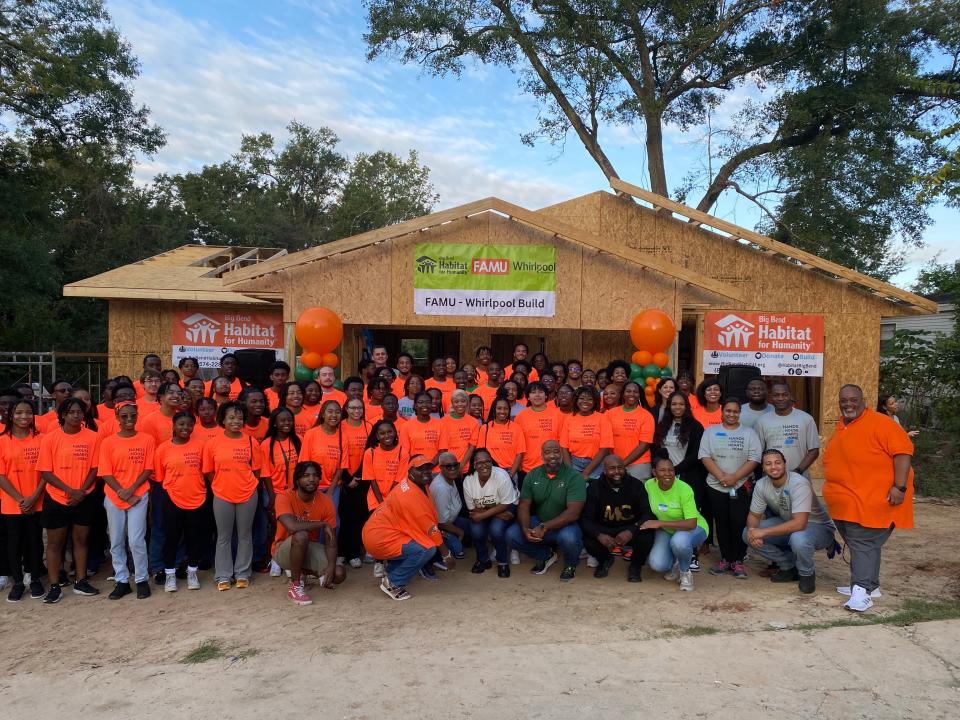 Students of FAMU-FSU College of Engineering's EESI program take a photo in front of the home under construction for a Tallahassee family on Disston Street along with members of the initiative's partnership.